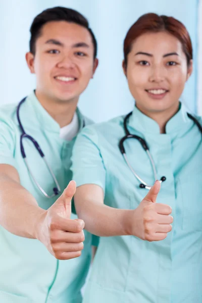 Coppia di dottori con gesto positivo — Foto Stock