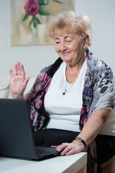 Elderly woman talking online — Stock Photo, Image