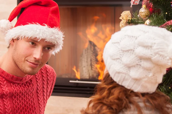 Couple sittng by the fireplace — Stock Photo, Image