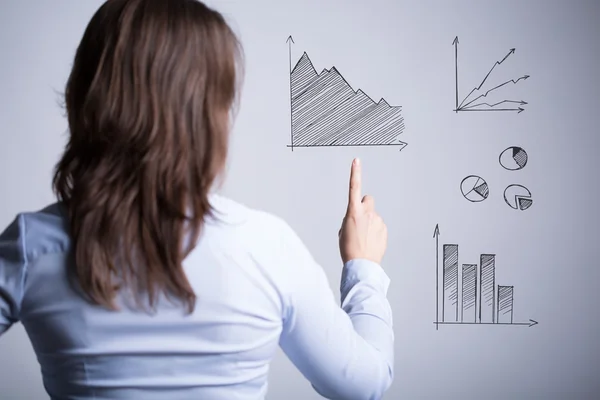 Woman among various charts — Stock Photo, Image