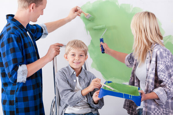 Loving family painting wall together