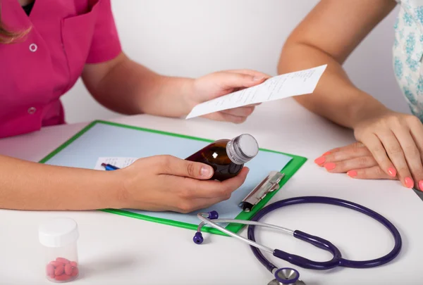 Doctor's hands giving patient prescription — Stock Photo, Image