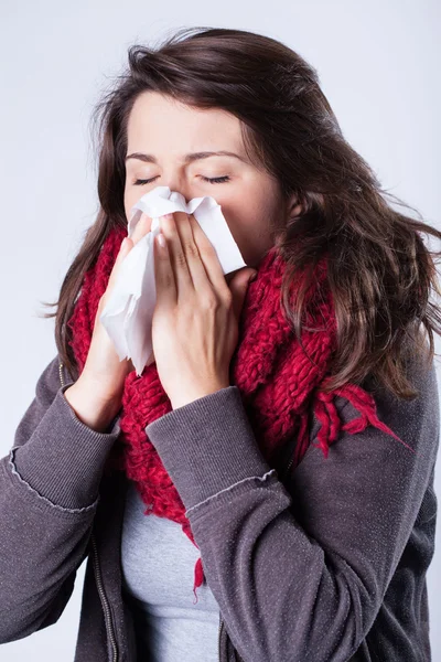 Woman in scarf sneezing — Stock Photo, Image