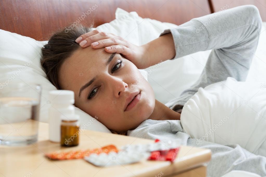 Ill woman feeling headache