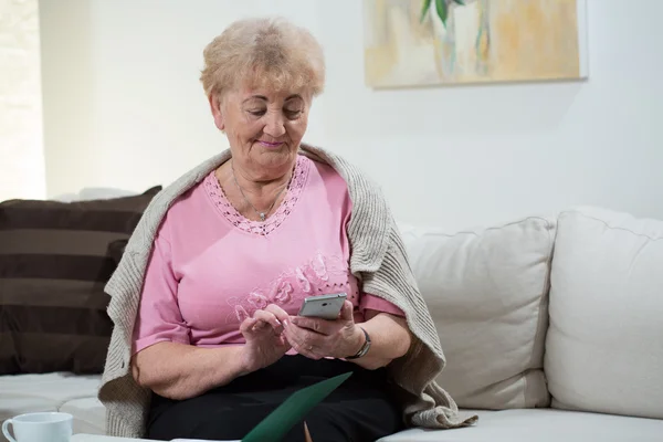 Ältere Frau benutzt Handy — Stockfoto