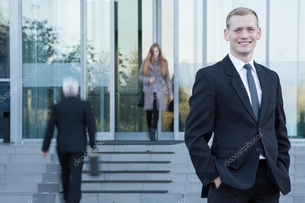 Businessman standing in front of office