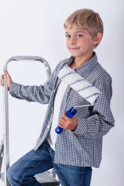 Child holding paint roller — Stock Photo, Image