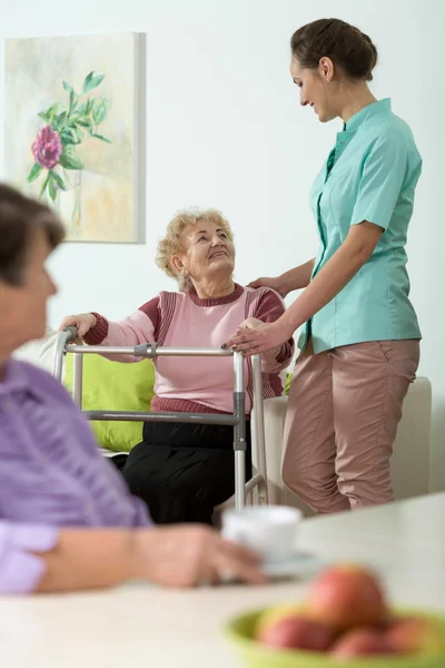 Nurse helping disabled woman Royalty Free Stock Images
