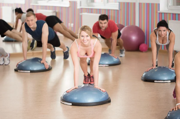 Push-ups on bosu — Stock Photo, Image