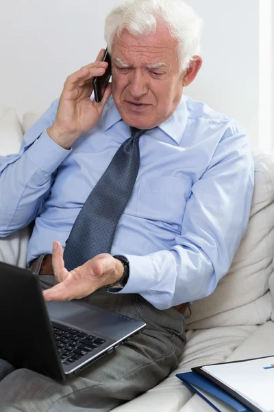 Geërgerd senior zakenman met behulp van laptop — Stockfoto