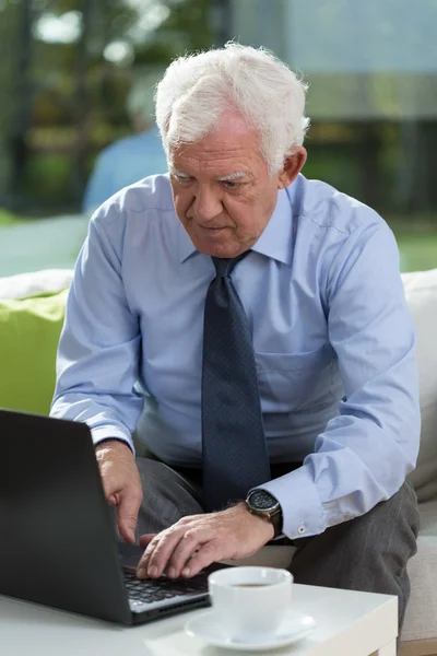 Senior businessman working on a laptop — Stock Photo, Image