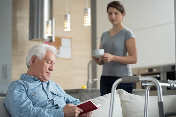 Granddaughter helping her disabled grandpa — Stock Photo, Image