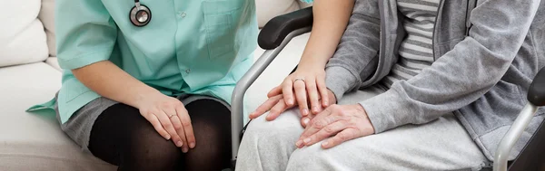 Doctor supporting disabled elderly — Stock Photo, Image