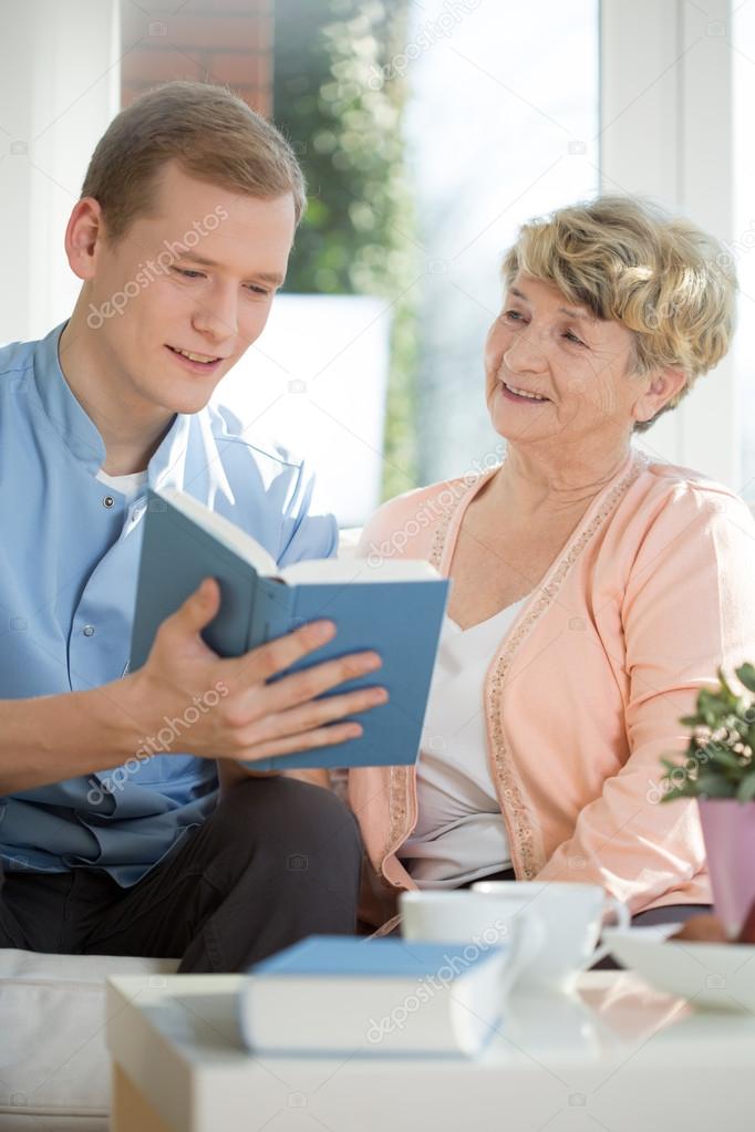 Male caregiver assisting senior woman