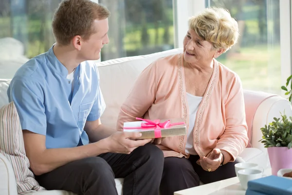 Senior vrouw geven gift — Stockfoto