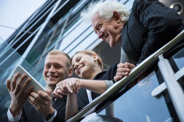 Smiling workers with tablet — Stock Photo, Image