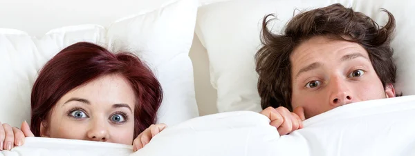 Couple under the sheet — Stock Photo, Image