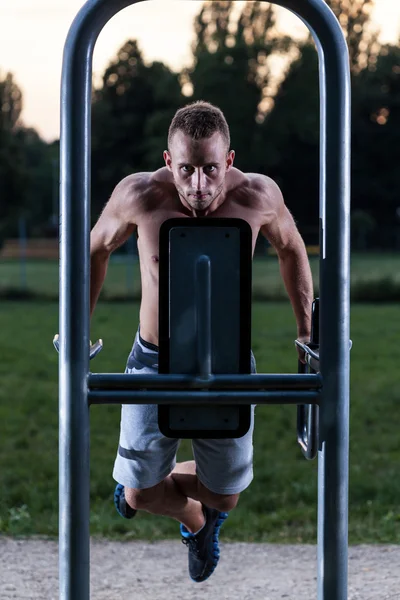 Hombre tirando hacia arriba en la máquina de ejercicios —  Fotos de Stock