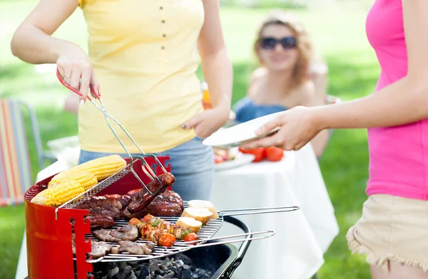 Host serving woman frazzled sausage — Stock Photo, Image