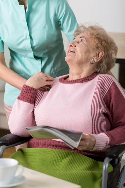 Old woman with magazine Stock Picture