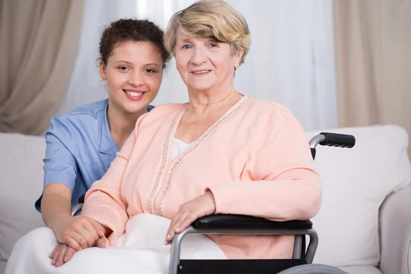 Disabled senior woman and carer — Stock Photo, Image