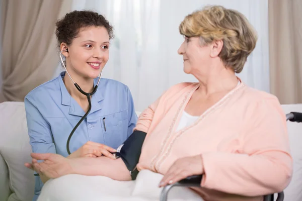 Young doctor during home visit — Stock Photo, Image