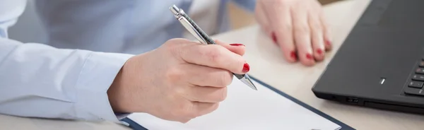Pen in the hand of businesswoman Stock Image