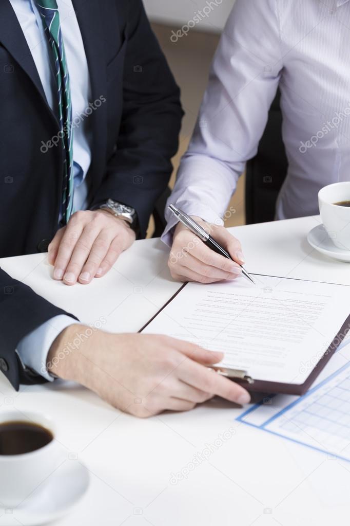 Businessperson signing important document