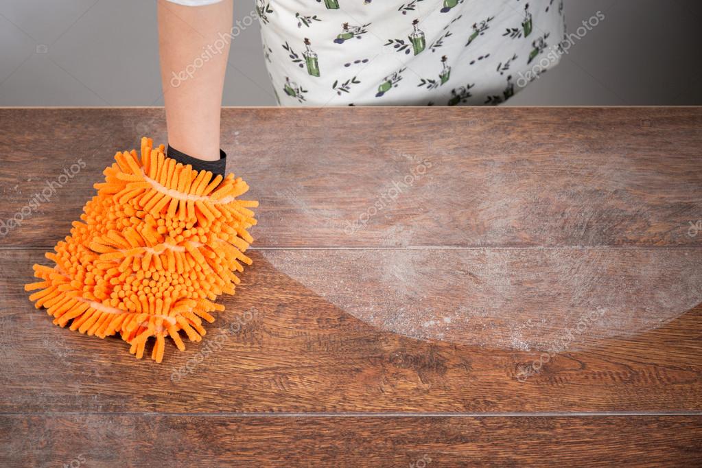 Woman cleaning dusty table Stock Photo by ©photographee.eu 71232553