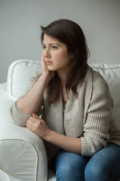 Worried girl sitting alone — Stock Photo, Image