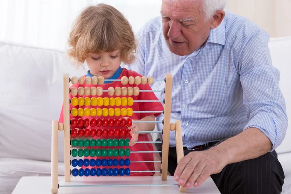 Kid playing with abacus toy — Stock Photo, Image