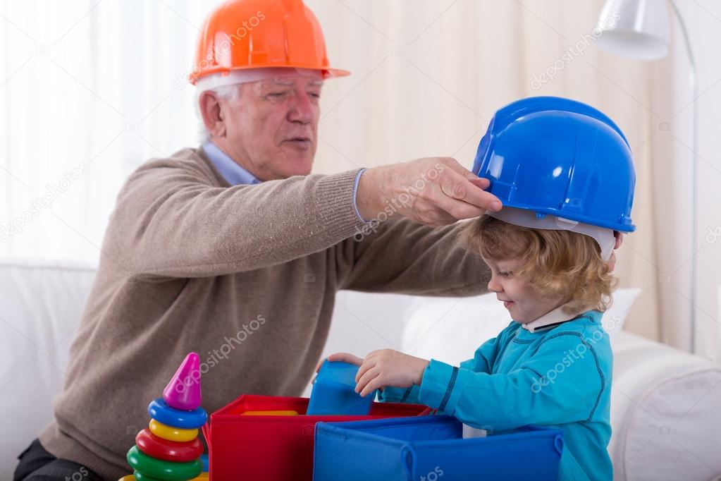 Grandfather and grandkid wearing helmets