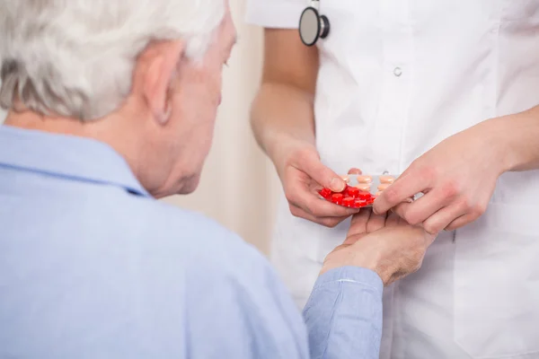 Close-up of giving medicine — Stock Photo, Image
