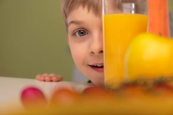 Boy hiding behind glass — Stock Photo, Image