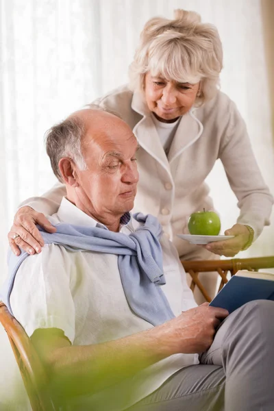 Senior woman caring about husband — Stock Photo, Image