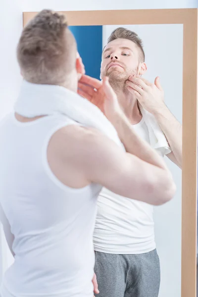 Attractive man caring about beard — Stock Photo, Image