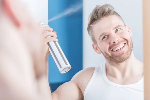 Uomo metrosessuale utilizzando lacca per capelli — Foto Stock