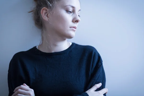 Sad woman in black sweater — Stock Photo, Image