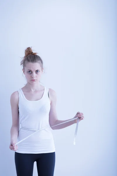 Anorexic girl measuring her waist — Stock Photo, Image