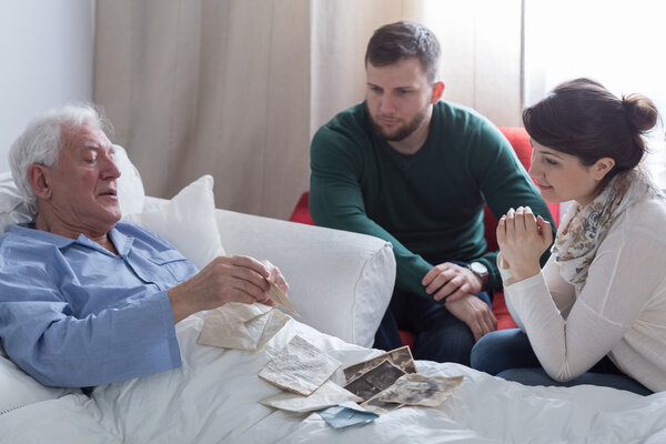 man showing old letter to his kids