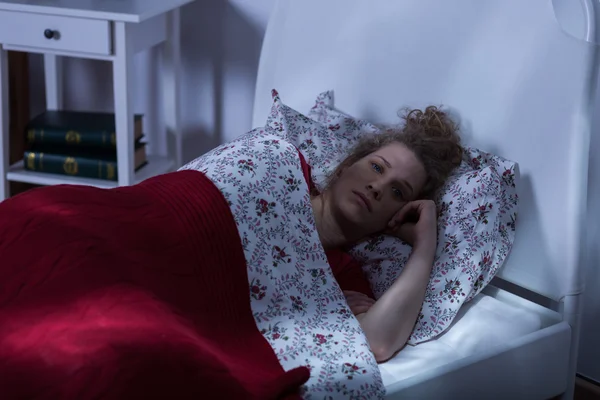 Молодая женщина, лежащая в постели — стоковое фото