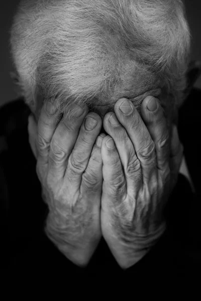 Hands covering face of old man — Stock Photo, Image