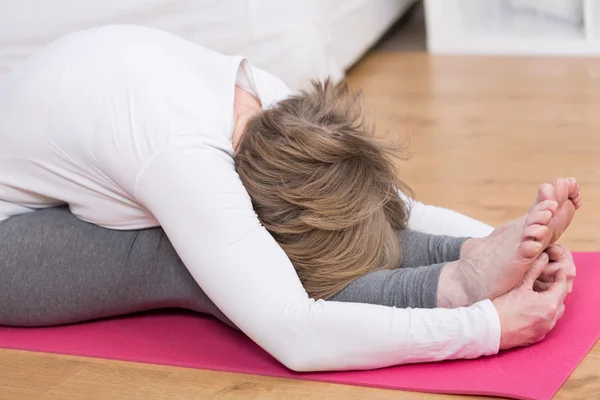 Woman seated forward bend — Stock Photo, Image