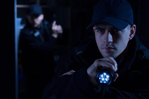 Police officer with torch — Stock Photo, Image