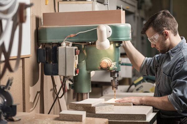 Carpenter using drill machine