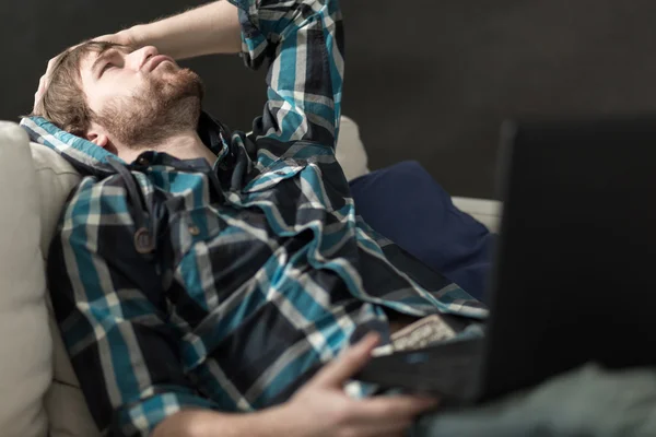 Depressed man sitting on the couch — Stock Photo, Image