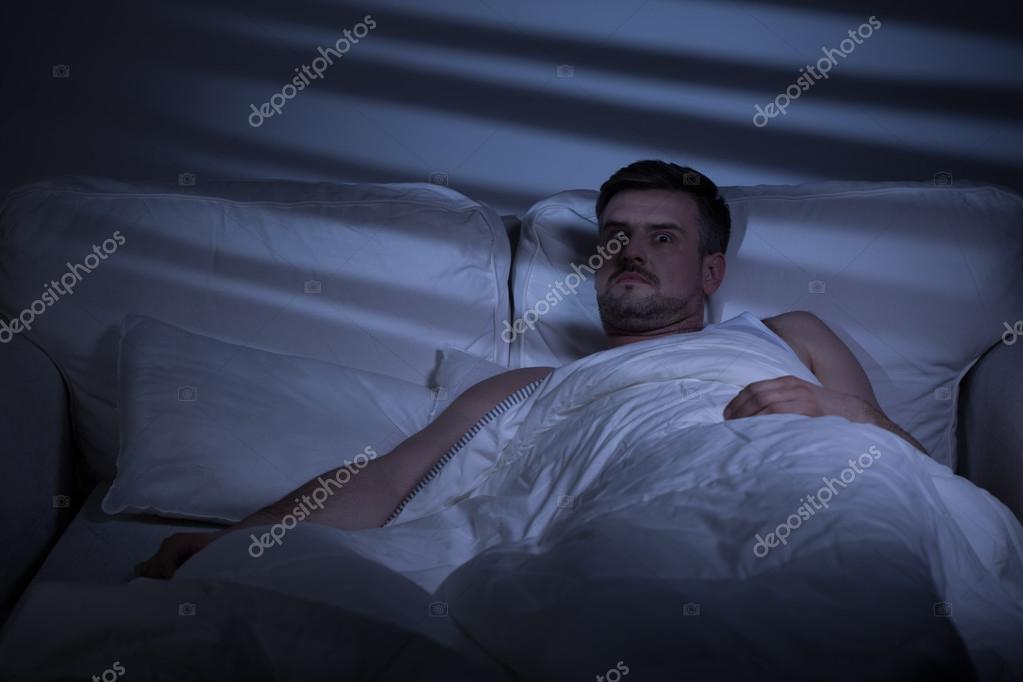 Terrified man in bed Stock Photo by ©photographee.eu 77331518