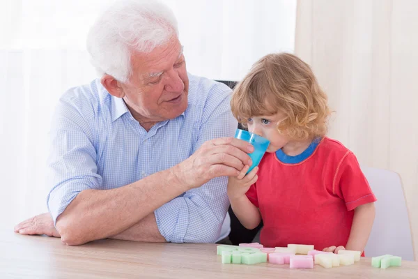 Helpful grandfather and boy — Stock Photo, Image