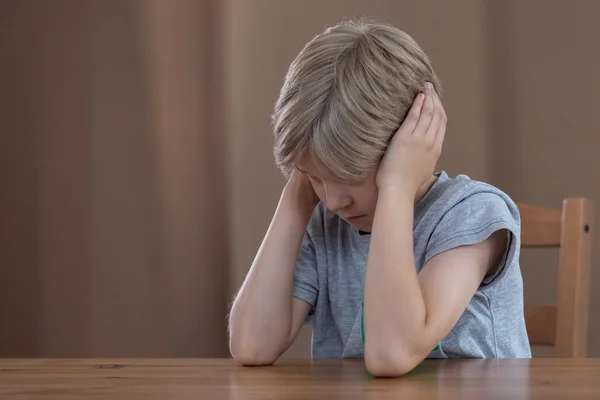 Depressed boy plugging ears — Stock Photo, Image