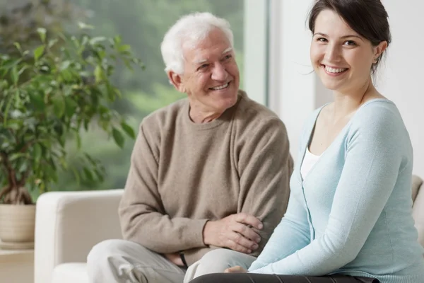 Smiling grandpa and caring granddaughter — Stock Photo, Image